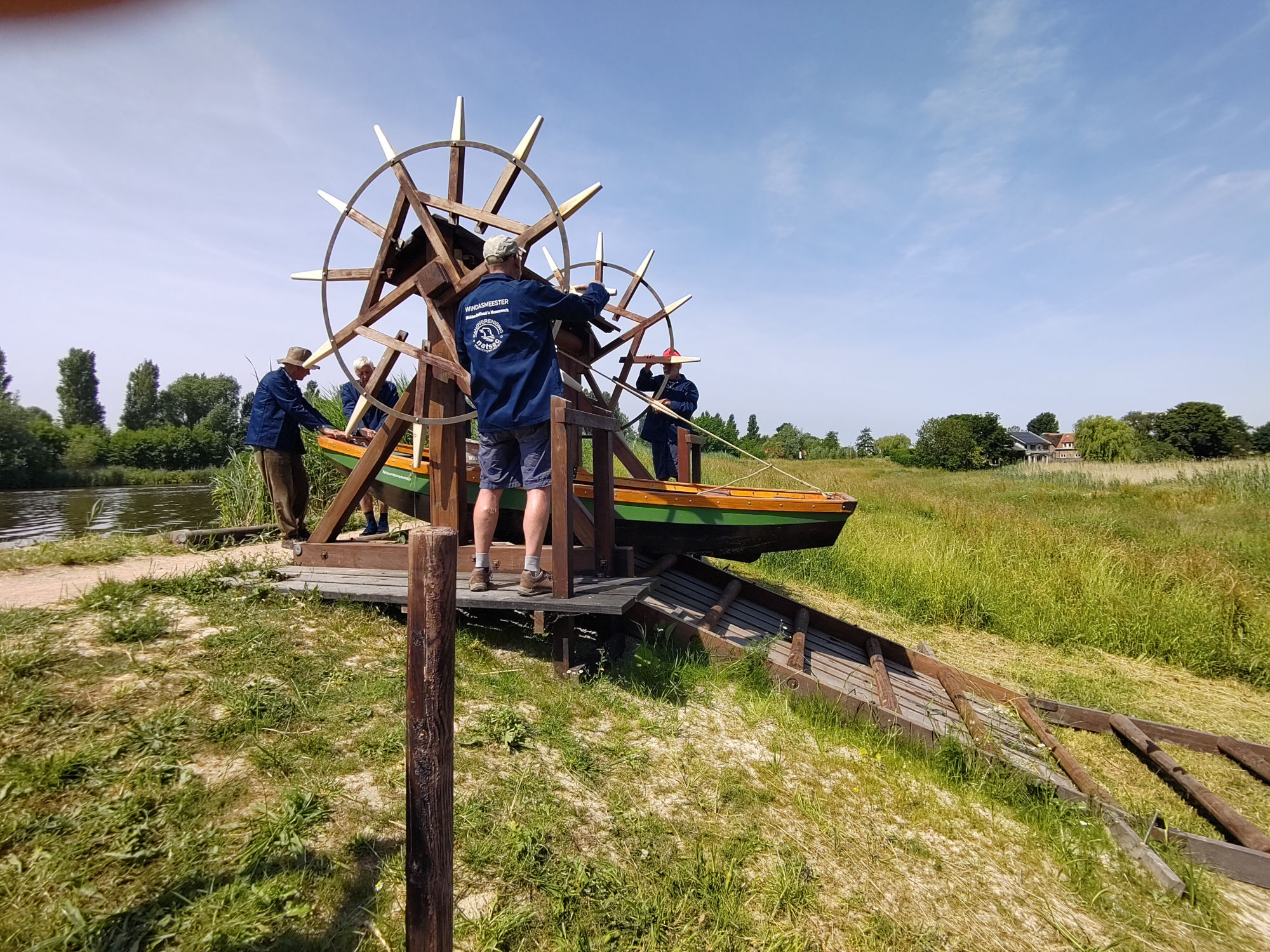 Een boot wordt met een windas over de dijk gehesen.